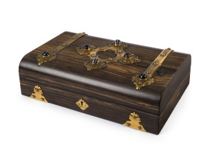 An antique games box, coromandel, gilt metal and cabochon agate, interior fitted with red leather and blue silk compartments housing ebony and ivory counters and scoreboards plus antique playing cards, 19th century, 9.5cm high, 30cm wide, 19cm deep