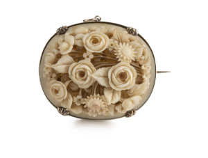 An antique oval brooch, sterling silver with finely carved ivory floral display, 19th century, 4 x 4.5cm