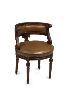 A French library chair, carved walnut with brown studded leather, 20th century, 52cm across the arms