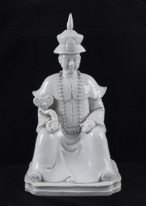 A Chinese Blanc de Chine statue of a seated Mandarin official, 20th century, double seal mark to base, 45cm high