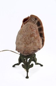 An Italian cameo carved shell with metal griffin base, 19th century, has been converted to an electric lamp, 21cm high