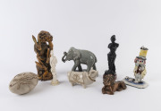 Chinese carved wooden statue of hares, Indian carved wooden statue of a woman, ceramic bull, lion, elephant and egg ornament as well as a ceramic clown statue, 20th century, (8 items), ​the largest 25cm high