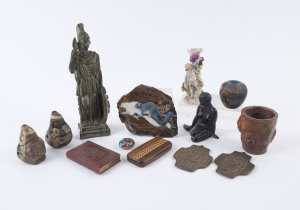 Bronze statues, South American pottery flutes, two bronze religious plaques, figural porcelain candlestick, possum ornament, cribbage board, pottery beaker, painted wooden vase, Murano millefiori glass ornament, and a souvenir of Riga musical book ornamen