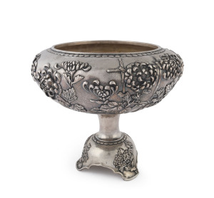 A fine Japanese silver centrepiece, hand beaten double walled construction with deep repoussé chrysanthemum motif in high relief, Meiji period, early 20th century, Jungin pure silver mark to base, ​24cm high, 27cm wide, 1260 grams