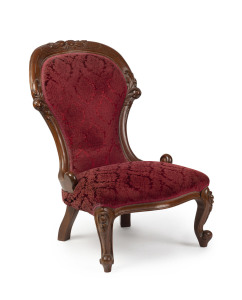 An antique parlour chair, walnut frame with carved red velvet upholstery, late 19th century,