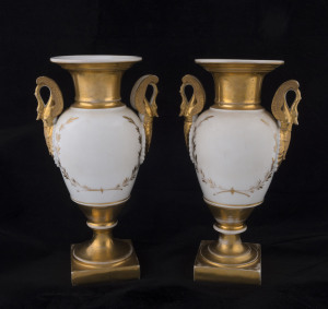 A pair of French gilded porcelain mantel urns with swan handles, circa 1830, ​26cm high