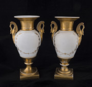 A pair of French gilded porcelain mantel urns with swan handles, circa 1830, ​26cm high