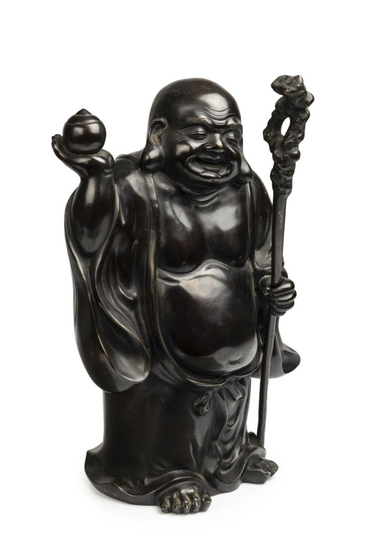 A Chinese smiling standing Buddha with peach, cast bronze, early to mid 20th century, 57cm high