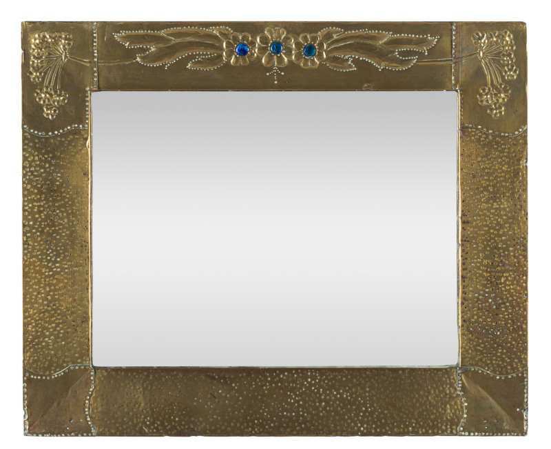 An English Arts and Crafts mirror, repoussé brass with enamel decoration, circa 1900, ​47 x 57cm