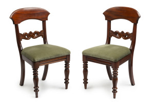 A pair of antique mahogany dining chairs with green upholstery, circa 1850,