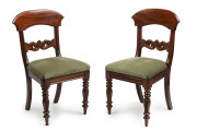 A pair of antique mahogany dining chairs with green upholstery, circa 1850, 