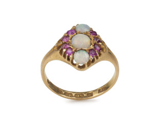 An antique English 18ct gold ring set with opals and rubies, 19th century, 3.2 grams total