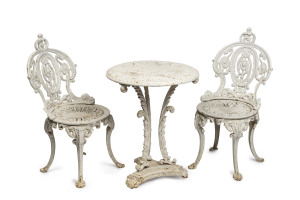 An antique cast iron table and two chairs, 19th century, the table 63cm high, 50cm diameter