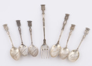 Six French silver souvenir teaspoons with armorial finials plus a silver plated fork, late 19th early 20th century, the fork 15.5cm long, the spoons 42 grams total