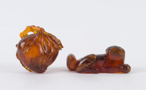 A Chinese carved amber figure of a cat and a carved amber scent bottle (no lid), 19th century, (2 items), the cat 6.5cm long