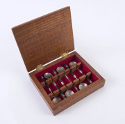 Set of six coffee spoons, the heads fashioned from 1940s-50s East Africa 1/- silver coins, ebonized handles, housed in lined rosewood box (14.5 x 16.5cm).