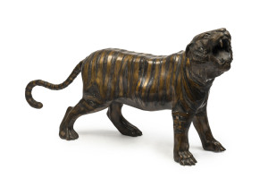 A Chinese bronze tiger statue, early 20th century, 62cm high,121cm long