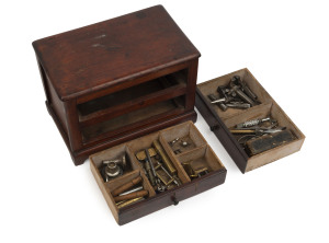 A collection of antique watch maker's tools in an antique cedar two drawer miniature chest, the chest 20cm high, 28cm wide, 18cm deep