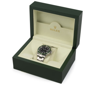 ROLEX SUBMARINER OYSTER DATE gent's wristwatch, stainless steel with green bezel. Mint condition in box with original booklets, wallet and papers, plus receipt issued by Langfords of Queen Street, Brisbane 12/6/2007 for $8,500. Never worn, still has origi