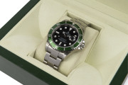 ROLEX SUBMARINER OYSTER DATE gent's wristwatch, stainless steel with green bezel. Mint condition in box with original booklets, wallet and papers, plus receipt issued by Langfords of Queen Street, Brisbane 12/6/2007 for $8,500. Never worn, still has origi - 2