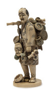 A Japanese statue of the basket seller, carved ivory, Meiji period, 19th century, two character mark to base, 20cm high, ​