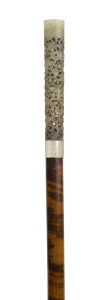 A Chinese walking stick with ornately carved jade handle, silver collar, Chinese tiger wood shaft and horn ferrule, 19th century, 97cm high