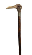 A walking stick, carved bone bird's head handle with glass eyes, silver collar, blackthorn shaft and brass ferrule, 19th century, 93cm long