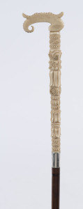 A walking cane, carved ivory handle with silver collar, cane shaft and brass ferrule, 19th century, 89cm high