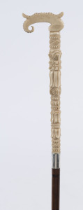 A walking cane, carved ivory handle with silver collar, cane shaft and brass ferrule, 19th century, ​89cm high