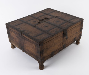 An Indian tax collection box, carved teak and iron, 19th century, 23cm high, 48cm wide, 41cm deep