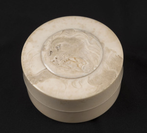 A Japanese circular box, carved ivory with lion decoration, Meiji period, 4cm high, 6.5cm diameter