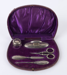 An English sterling silver manicure set in original plush fitted case, made in Birmingham, circa 1916, the case 20.5cm wide