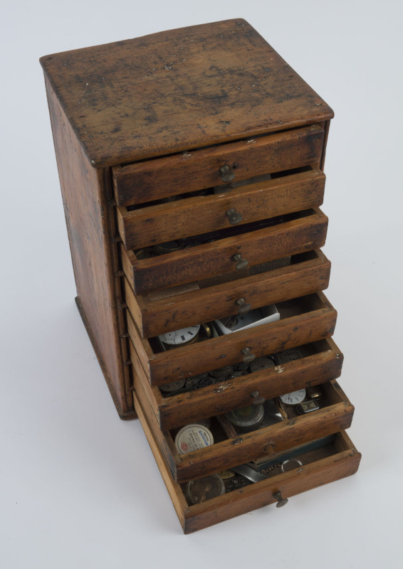 Watch maker's eight drawer miniature chest with large quantity of movements and parts, 32cm high, 21cm wide, 20cm deep