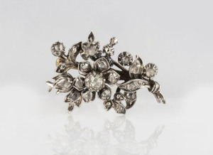 An antique diamond floral cluster brooch, silver topped with gold back, 19th century, 4cm wide, 9.5 grams