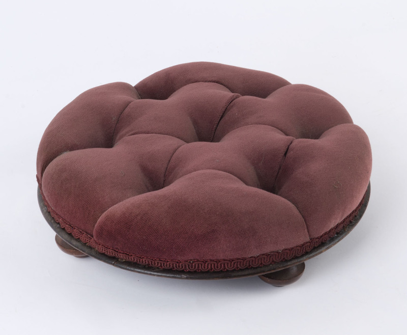 A circular footstool with plum velvet button upholstery, 19th century, ​10cm high, 32cm diameter