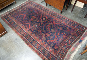 A Persian handwoven rug, red and blue on brown background, early to mid 20th century, 350cm x 197cm