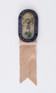 1956 MELBOURNE - OFFICIAL'S PIN BADGE: in oxidised silver with blue enamelled border and emamelled olympic rings, torch and map of Australia, ribbon intact, stamped '3205' on reverse, made by K.C. Luke (Melbourne), 51x30mm, weight 20gr. Issued to sports and team officials.