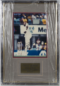 WEST INDIES - CURTLY AMBROSE: signed photograph (24x18cm) of the great West Indian fast bowler in action, attactively mounted, framed and glazed; overall 47x33cm.