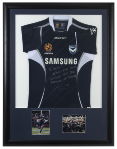 MELBOURNE VICTORY - ARCHIE THOMPSON: 2007 display featuring team jersey with signed dedication by Archie Thompson, inset images of Thompson and the 2007 Premiership team beneath; attractively framed & glazed, overall 110x85cm.