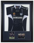 MELBOURNE VICTORY - ARCHIE THOMPSON: 2007 display featuring team jersey with signed dedication by Archie Thompson, inset images of Thompson and the 2007 Premiership team beneath; attractively framed & glazed, overall 110x85cm.