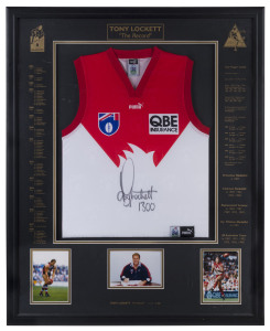 TONY LOCKETT (Sydney Swans): AFL limited edition framed & glazed display, commemorating Lockett breaking the all-time AFL kicking record when booting his 1300th career goal, complete with signed guernsey and three inset photographs of Lockett, CofA numbered 1094/1300; overall 88x110cm.