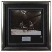 JOE FRAZIER vs MUHAMMAD ALI: action photograph of Ali falling into the ropes after being caught by Frazier's famed left hook during the 11th round of "The Fight of The Century" held at Madison Square Garden, March 8, 1971, SIGNED BY FRAZIER with a silver