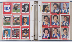 1980s-90s Scanlens & Stimorol cards, haphazardly laid out by club and affixed with cellotape into photo album, comprising Brisbane (6), Carlton (27), Collingwood (25), Essendon (26) Fitzroy (25), Footscray (16), Geelong (27), Hawthorn (29), Melbourne (27), North Melbourne (36), Richmond (27), St Kilda (27), Sydney (24), West Coast (5); mixed condition. (327)