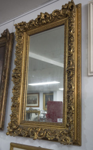 An English ornate gilt framed mirror, circa 1860, 95 x 60cm