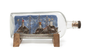 A four masted ship in a bottle, ​25cm long