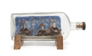 A four masted ship in a bottle, ​25cm long