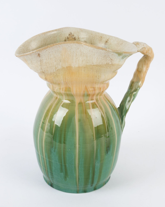 REMUED pottery green glazed jug with applied branch handle, incised "Remued 98L", 26cm high