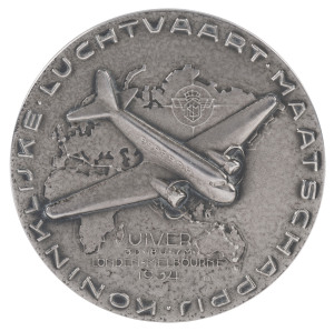 THE LONDON to MELBOURNE MacROBERTSON CENTENARY AIR RACE 1934 Silver medal created to honour the winning entry, the "Uiver", 50mm diameter and depicting the aeroplane, a KLM Douglas DC2 in flight over a map depicting the route (obverse) and with the names 