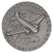 THE LONDON to MELBOURNE MacROBERTSON CENTENARY AIR RACE 1934 Silver medal created to honour the winning entry, the "Uiver", 50mm diameter and depicting the aeroplane, a KLM Douglas DC2 in flight over a map depicting the route (obverse) and with the names