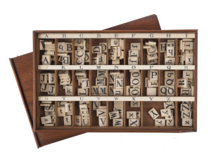 AN ALPHABET SET, England, circa 1830s-40s. A set of bone letter blocks, each approx. 15 x 18mm, 184 pieces, with upper and lower case letters incised and completed in black ink (mostly) by hand; in original cedar box with 27 internal compartments in 3 row